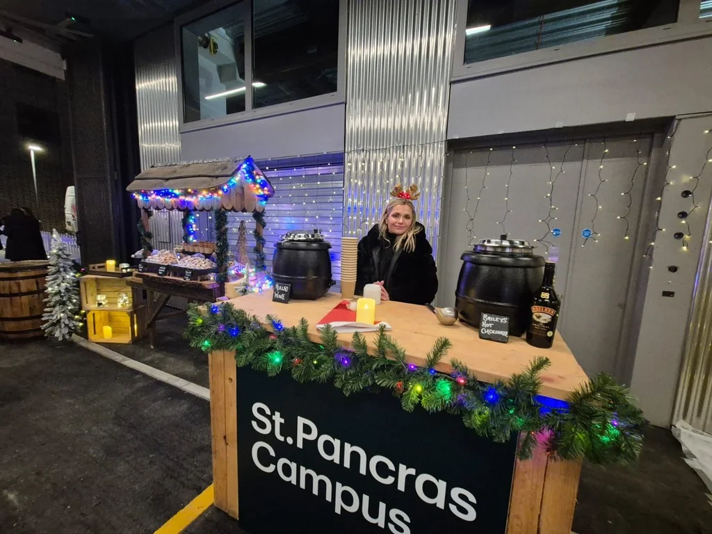 Wooden Christmas market bar with St Pancras Campus branding