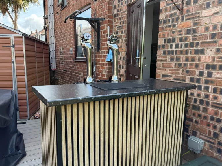 Asahi Super Dry and Guinness taps on a slat-front portable bar for a garden party in Bootle