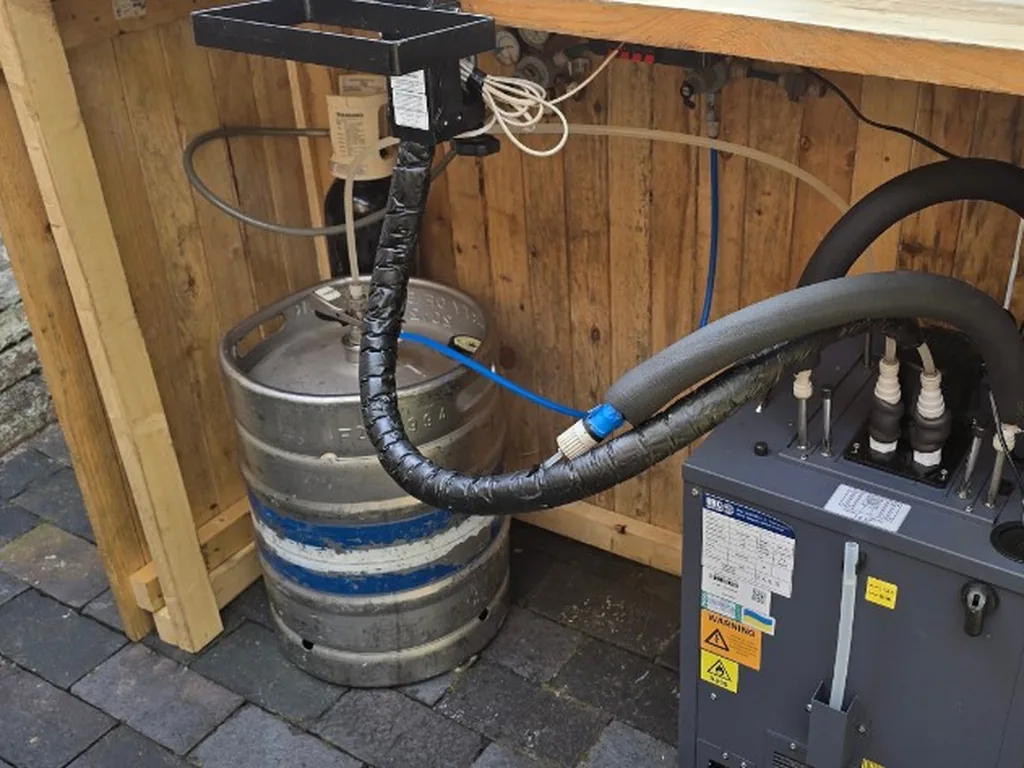 Keg, flash cooler and gas under a rustic bar in a Warwick courtyard