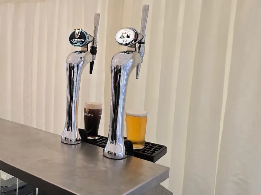 Guinness Extra Cold and Asahi Super Dry taps on a portable bar in a Warwick wedding marquee