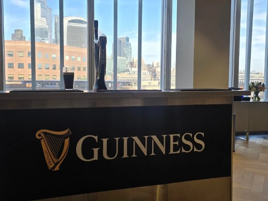 Guinness-branded stainless portable bar with a harp tap in a London office