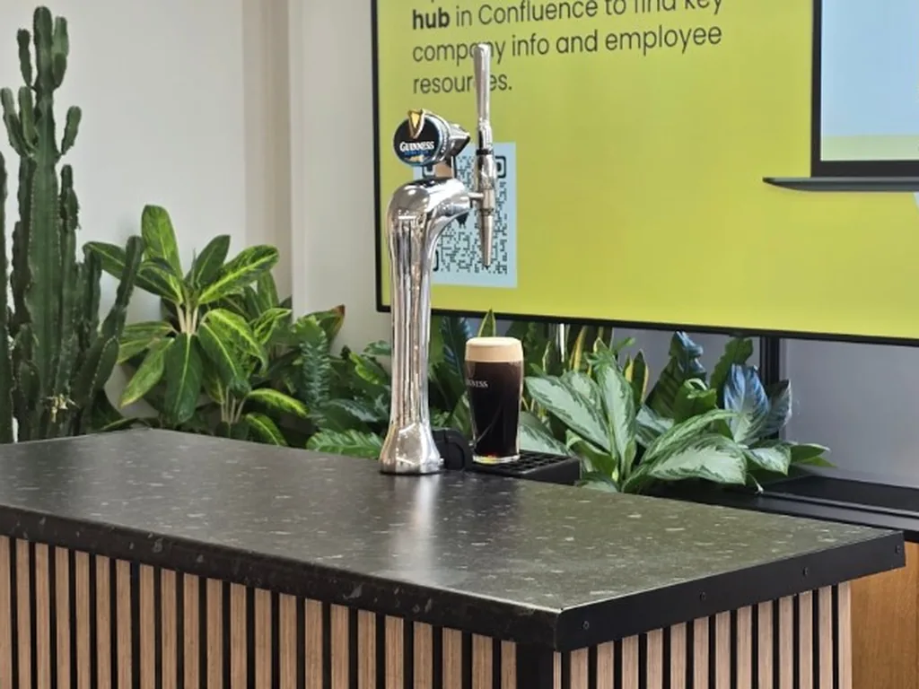 Guinness chrome tap and poured pint on a slat-front portable bar at Bumble's office in Soho, London