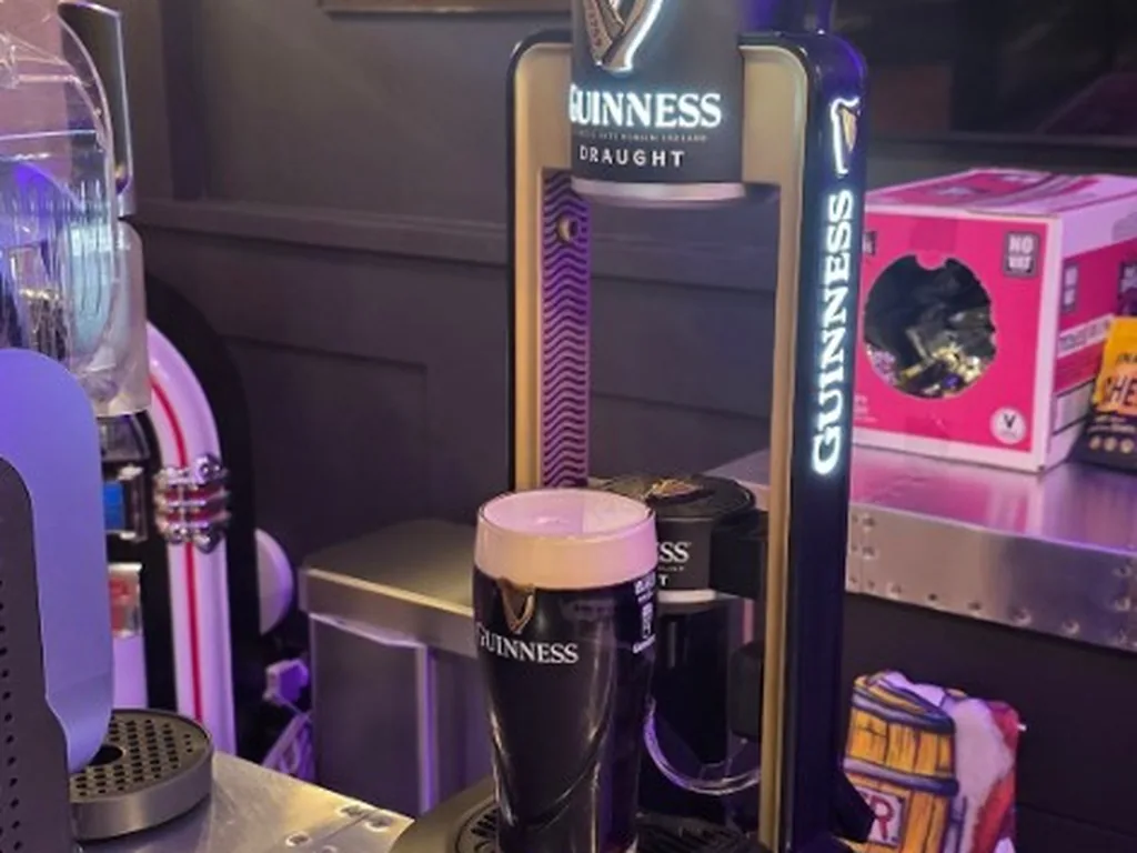 Guinness MicroDraught unit and poured pint on a bar in Essex