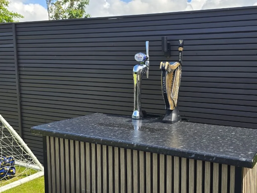 Guinness and Peroni taps on a slat-front portable bar in a Liverpool garden