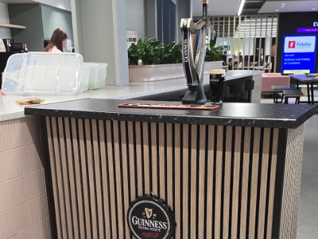 Slat-front portable bar with a Guinness Extra Stout badge in an office near Waterloo
