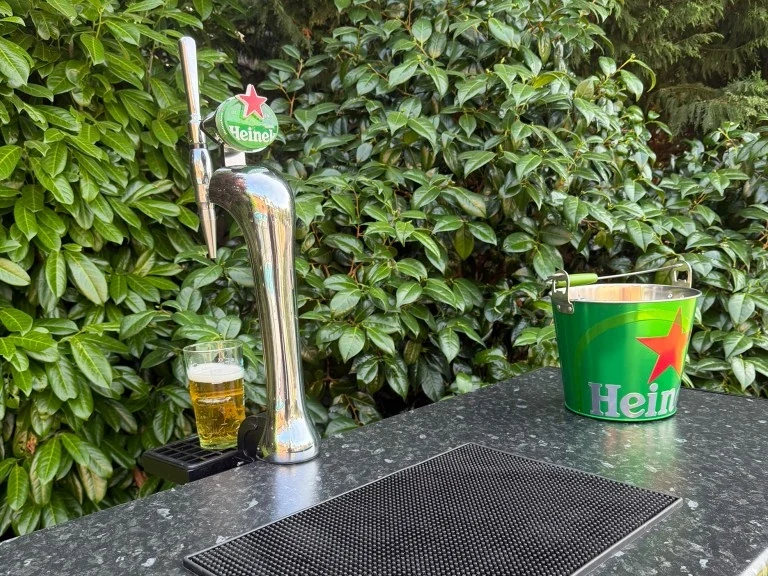 Slat-front portable bar with a Heineken tap and ice bucket in a Warrington garden