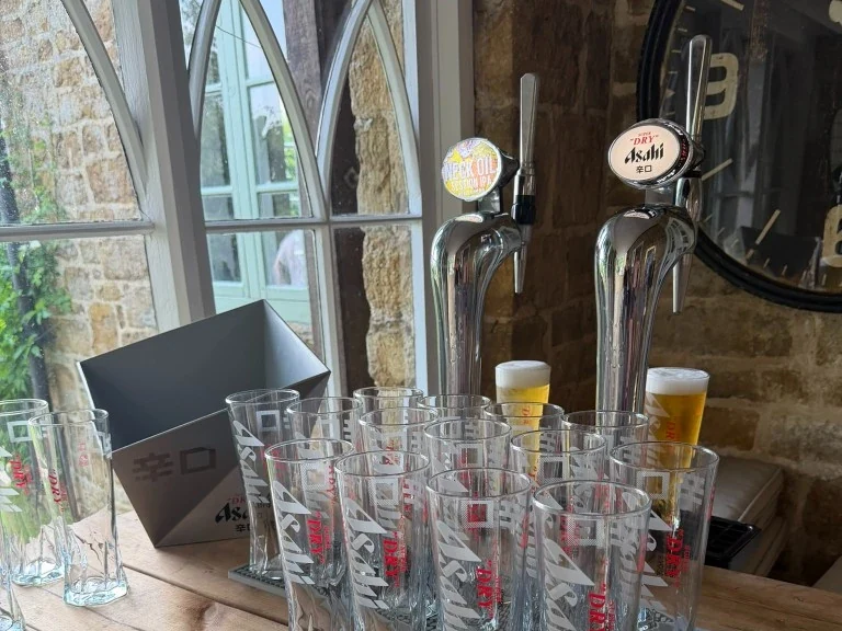 Beavertown Neck Oil and Asahi Super Dry keg hire on a rustic wooden bar near Chipping Norton