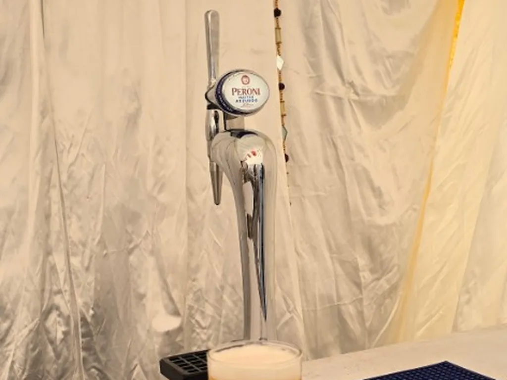 Peroni Nastro Azzurro tap and poured lager in a Heathcote marquee