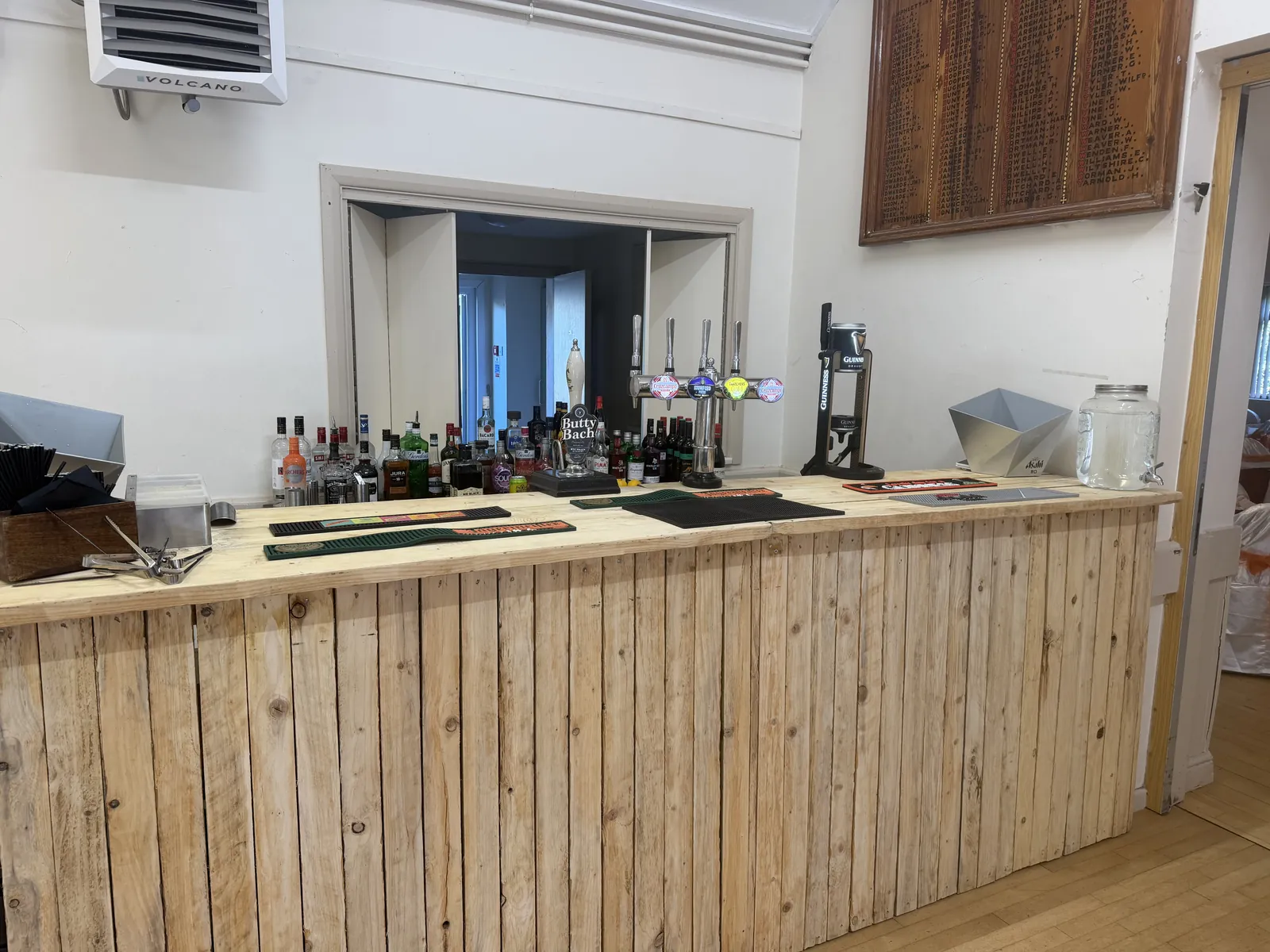 Rustic pallet-wood wedding cash bar at Leigh Sinton Memorial Hall near Malvern, Worcestershire