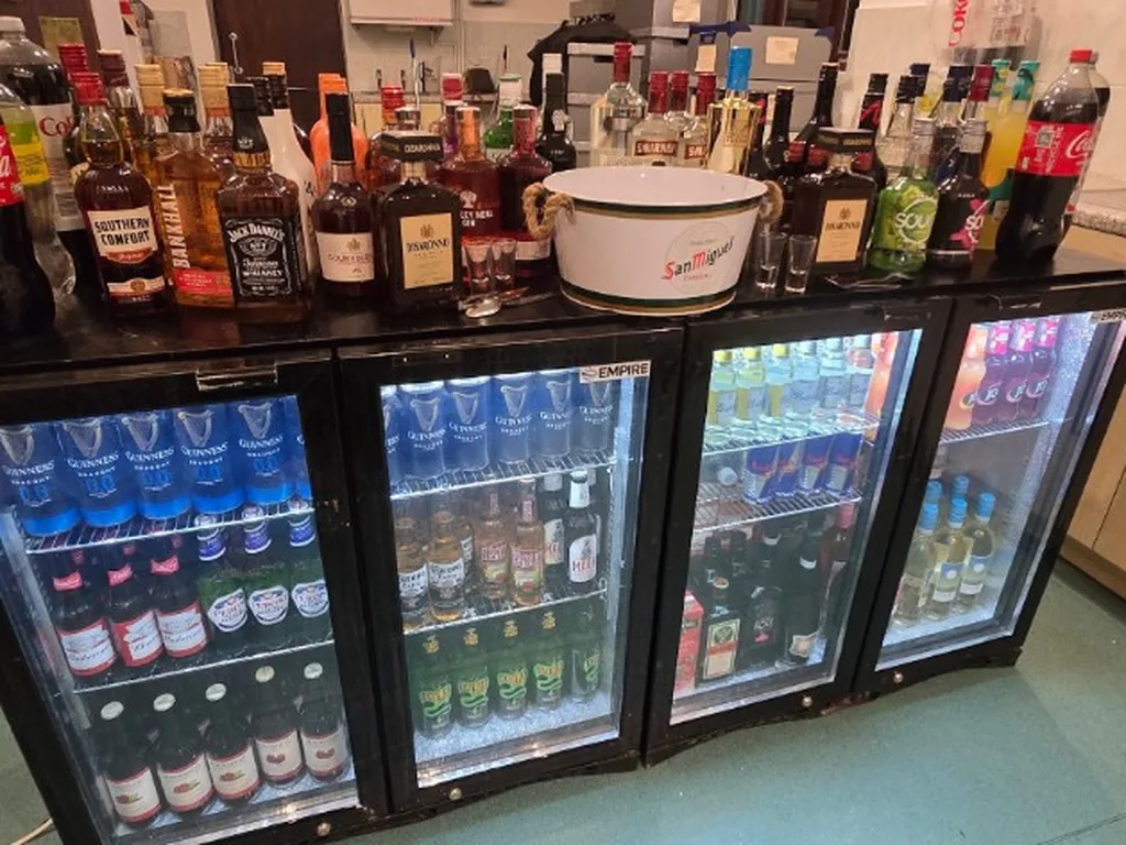 Empire bottle fridges and spirits on the back bar at Lifford Hall, Broadway