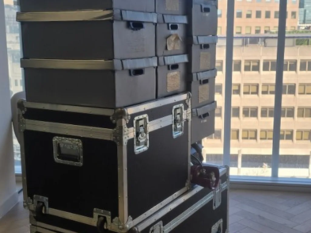 Flight cases and kit stacked in a London office after going up in the building