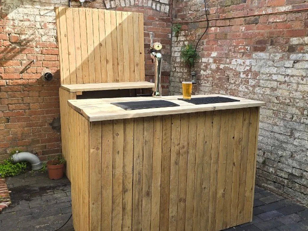 Rustic wooden bar and chrome tap in a Warwick courtyard