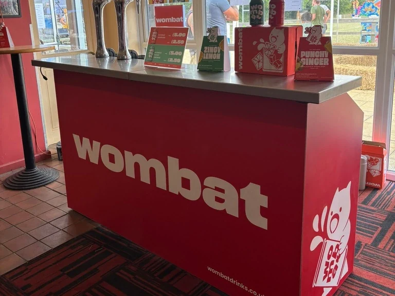 Wombat-branded portable bar hire with a vinyl wrap and dual chrome taps